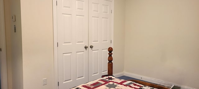 bedroom featuring a closet and baseboards
