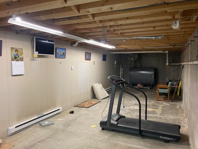 exercise room featuring a baseboard radiator and concrete floors