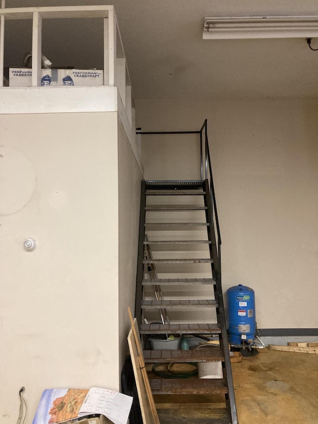 stairway with concrete flooring