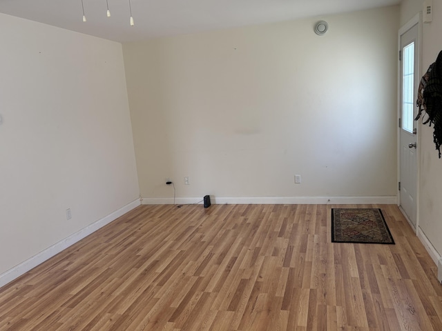 interior space with baseboards and light wood finished floors