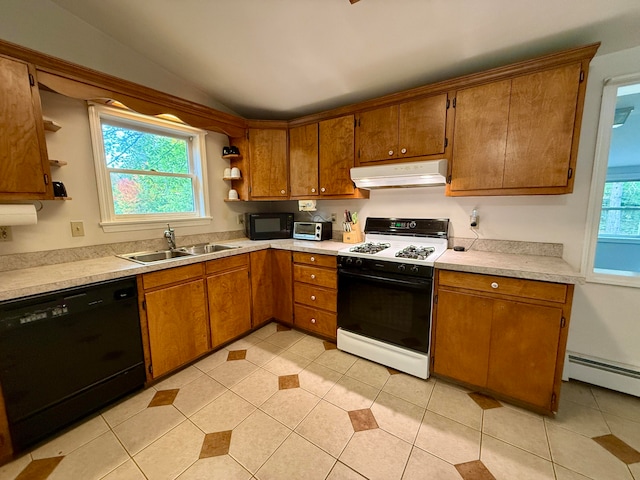 kitchen with a healthy amount of sunlight, black appliances, lofted ceiling, and sink