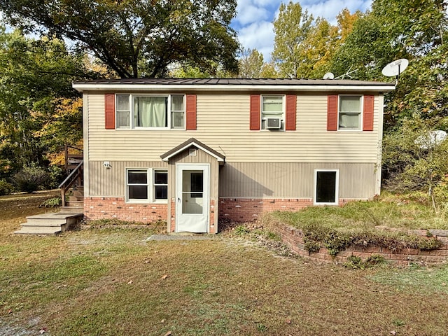 view of front of home with cooling unit and a front yard