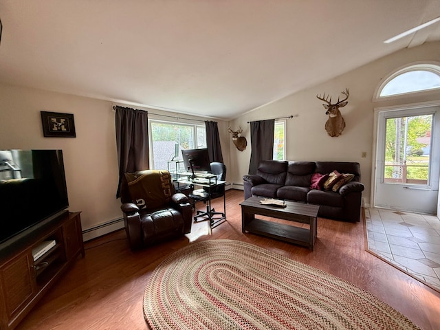 living room with hardwood / wood-style floors, plenty of natural light, and vaulted ceiling