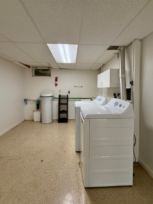 laundry area featuring separate washer and dryer and cabinets