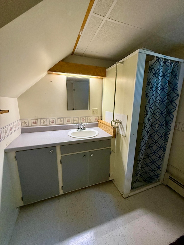 bathroom featuring vanity, vaulted ceiling, and a shower with curtain