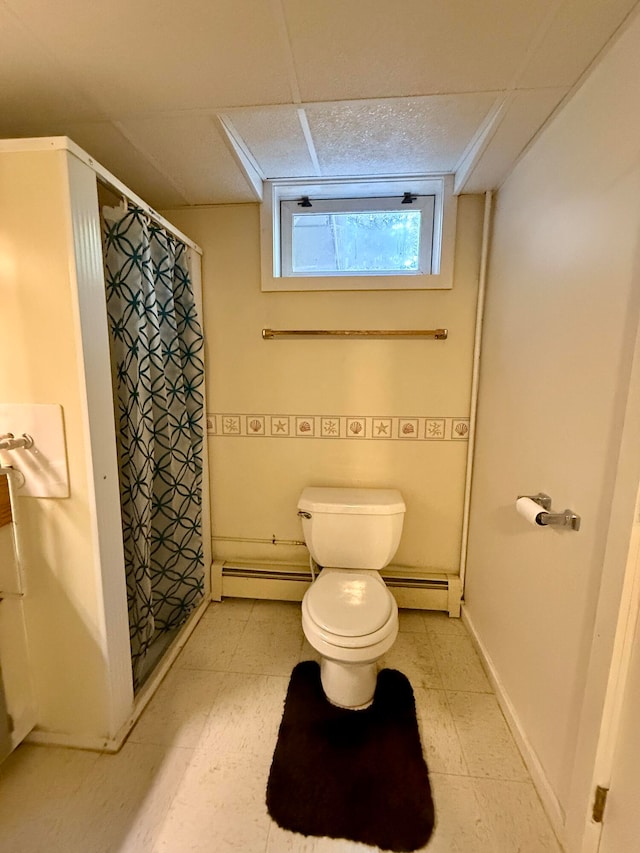 bathroom with toilet, a shower with shower curtain, and a baseboard radiator