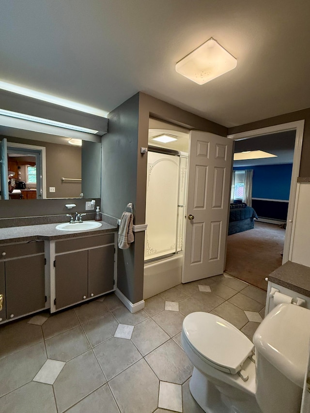 bathroom featuring walk in shower, vanity, toilet, and tile patterned floors