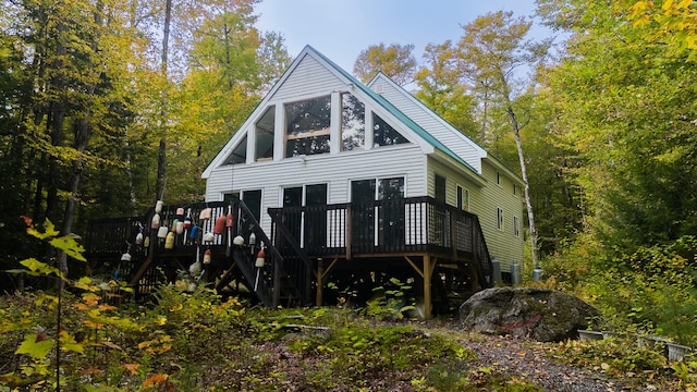 rear view of property with a wooden deck