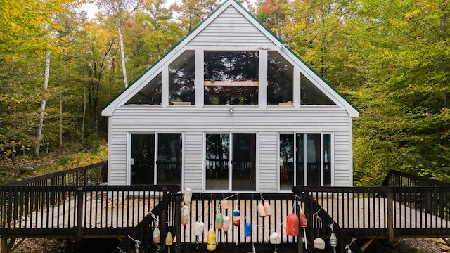 rear view of house featuring a wooden deck