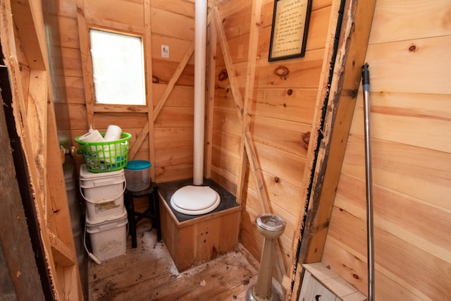 bathroom featuring wooden walls