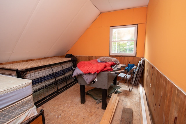 bedroom with wooden walls and vaulted ceiling