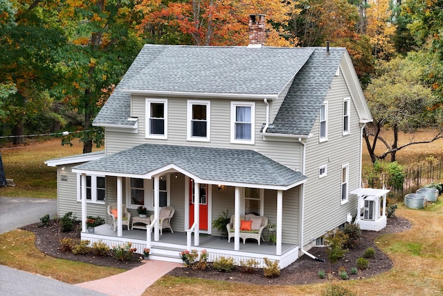 459 Durham Rd, Brunswick, ME 04011 - view of front of home with a shingled roof, covered porch, a chimney, fence, and a cooling unit