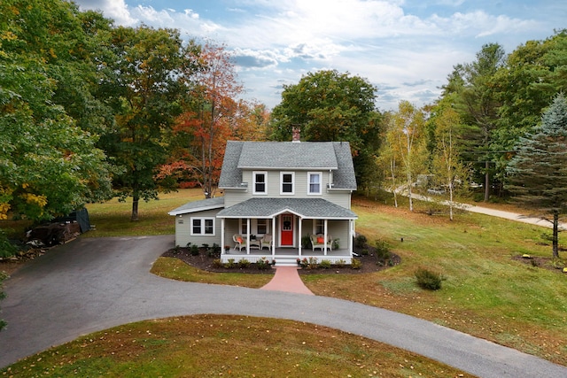 459 Durham Rd, Brunswick, ME 04011 - view of front of house with covered porch, asphalt driveway, a front yard, and a chimney