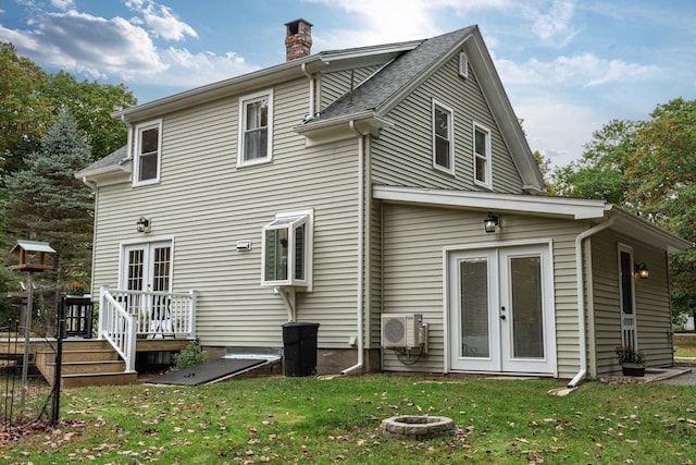 459 Durham Rd, Brunswick, ME 04011 - rear view of house featuring french doors, a chimney, a lawn, a deck, and ac unit