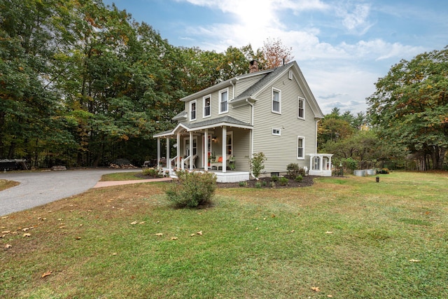 459 Durham Rd, Brunswick, ME 04011 - view of property exterior with a porch, a chimney, and a yard