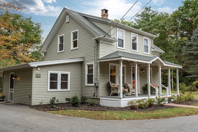 459 Durham Rd, Brunswick, ME 04011 - view of front of house with a porch, a chimney, and roof with shingles