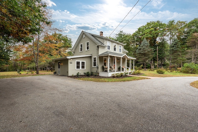 459 Durham Rd, Brunswick, ME 04011 - view of front of property with a porch, a chimney, and asphalt driveway