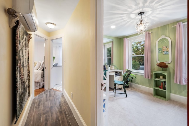 459 Durham Rd, Brunswick, ME 04011 - hall with a wall mounted AC, a chandelier, baseboards, and dark wood-type flooring