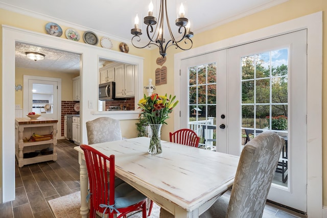 459 Durham Rd, Brunswick, ME 04011 - dining space with a chandelier, ornamental molding, french doors, and dark wood finished floors