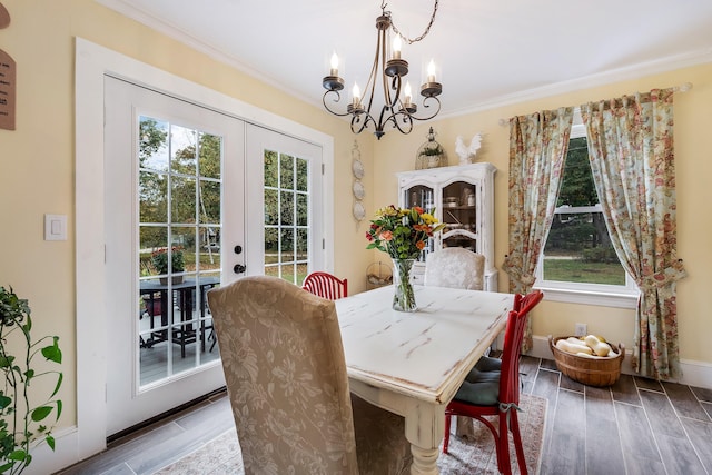 459 Durham Rd, Brunswick, ME 04011 - dining area with french doors, a chandelier, wood finished floors, ornamental molding, and baseboards
