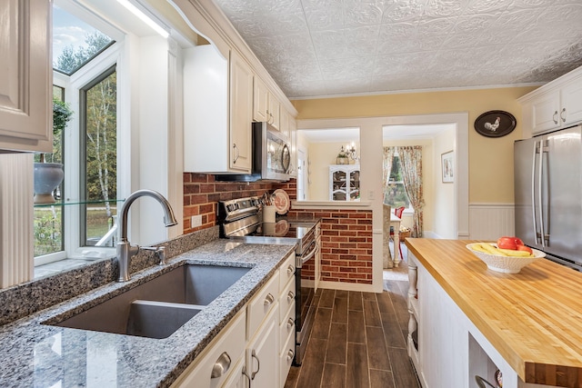 459 Durham Rd, Brunswick, ME 04011 - kitchen with stainless steel appliances, wooden counters, a sink, healthy amount of natural light, and wainscoting