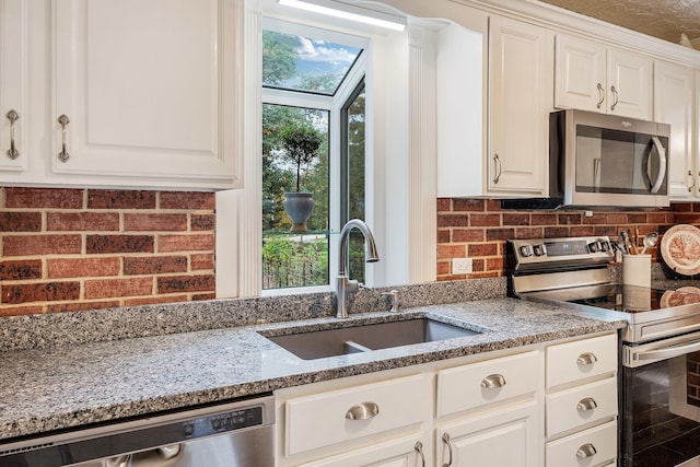 459 Durham Rd, Brunswick, ME 04011 - kitchen with stainless steel appliances, a sink, light stone countertops, and decorative backsplash