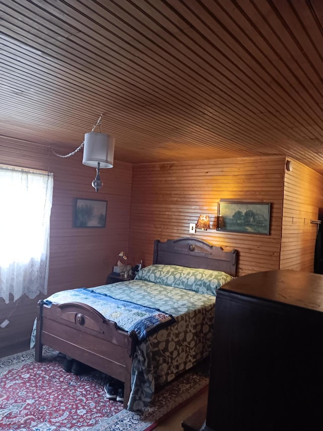 bedroom featuring wooden walls and wooden ceiling