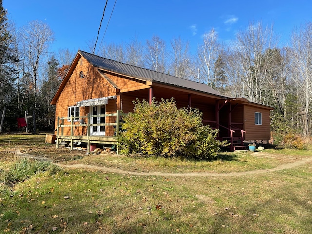 view of side of home with a lawn