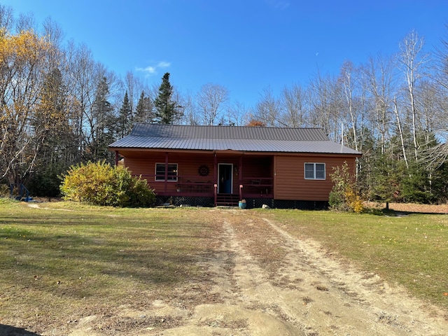 ranch-style home with covered porch and a front yard