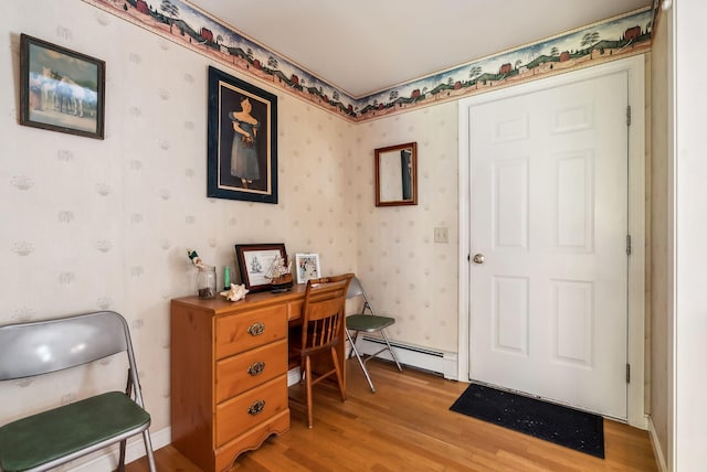 office space featuring a baseboard radiator and light hardwood / wood-style flooring