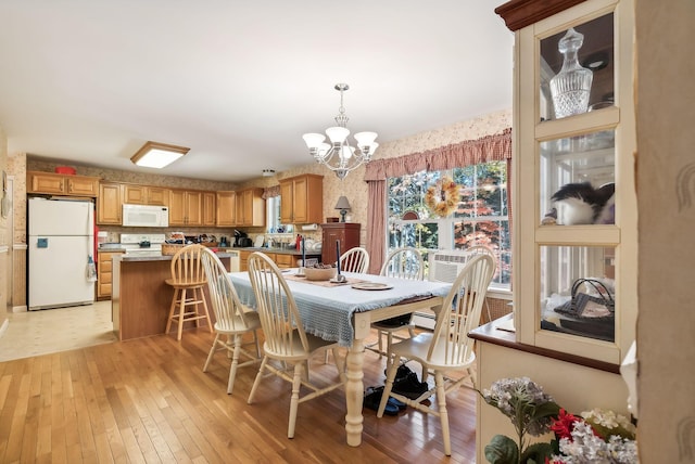 dining room featuring a chandelier and light wood-type flooring