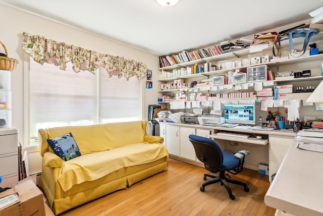 home office featuring built in desk, a healthy amount of sunlight, and light wood-type flooring