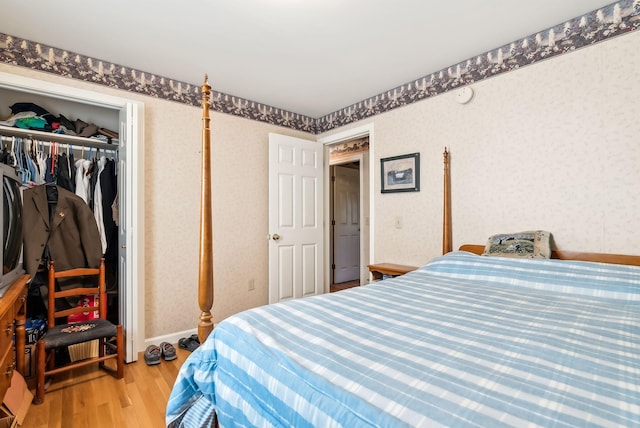 bedroom with hardwood / wood-style floors and a closet