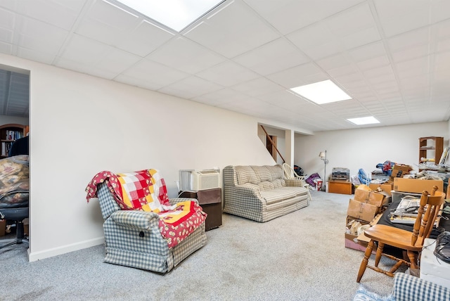 carpeted living room with a paneled ceiling