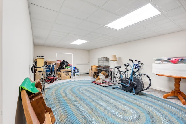 interior space featuring a baseboard radiator, a drop ceiling, and carpet