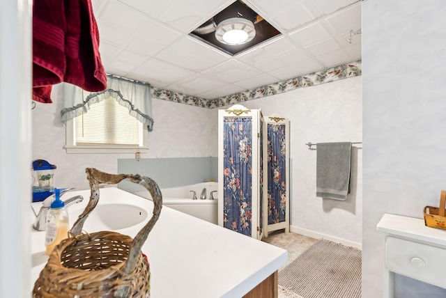 bathroom with sink and a paneled ceiling