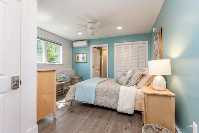 bedroom featuring dark hardwood / wood-style floors, ceiling fan, a wall mounted AC, and baseboard heating