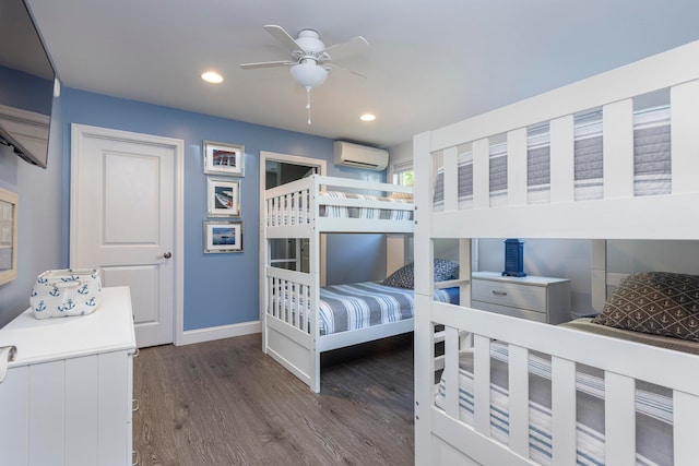 bedroom with dark wood-type flooring, a wall mounted air conditioner, and ceiling fan