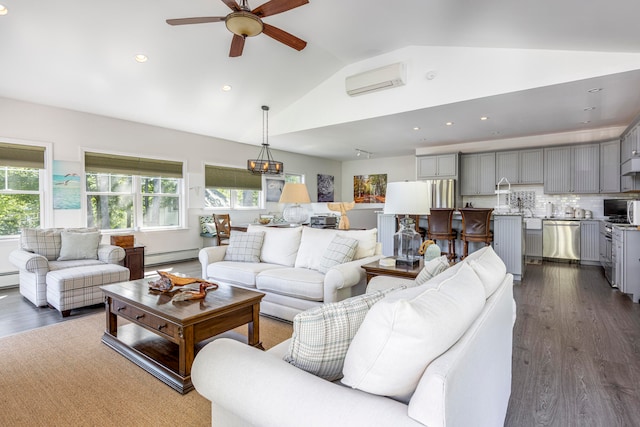 living room featuring lofted ceiling, an AC wall unit, baseboard heating, and a wealth of natural light