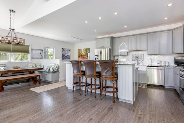 kitchen with a kitchen island, gray cabinets, and stainless steel appliances