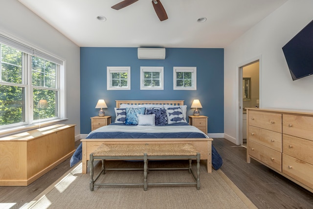 bedroom featuring dark hardwood / wood-style floors, a wall mounted AC, and ceiling fan