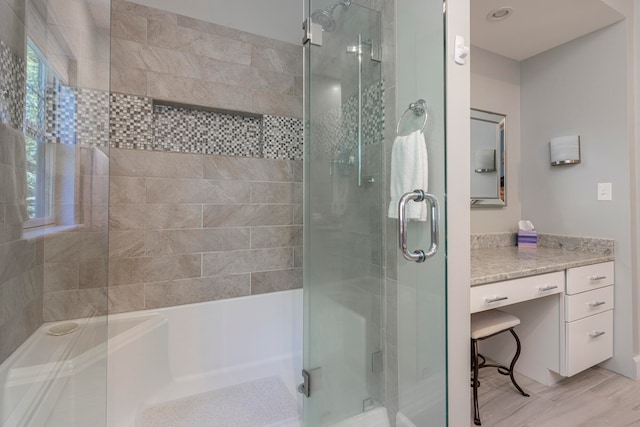 bathroom featuring shower with separate bathtub, hardwood / wood-style floors, and vanity