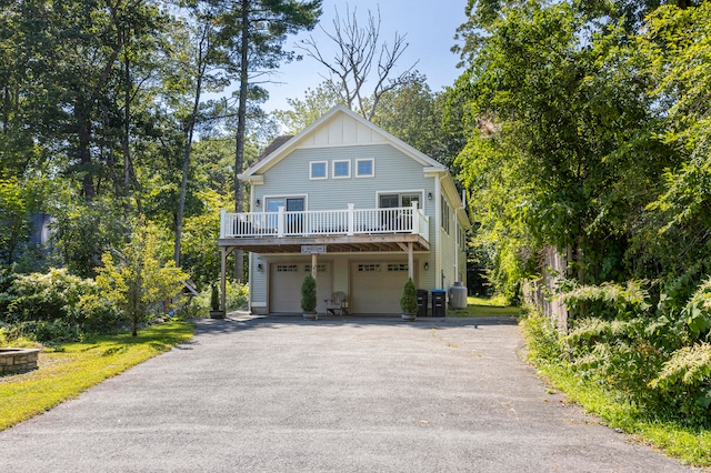 view of front of house with central air condition unit and a garage