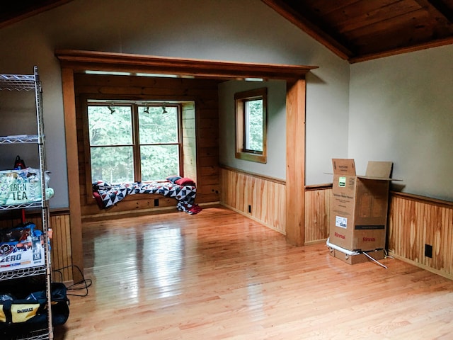 552 Egypt Rd, Alna, ME 04535 - interior space with wood walls, light wood finished floors, wainscoting, and vaulted ceiling
