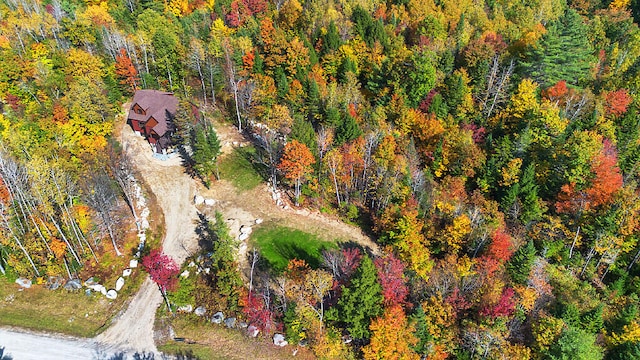 drone / aerial view with a wooded view