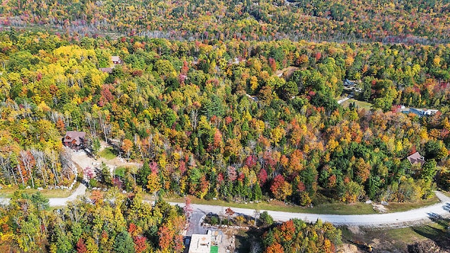 birds eye view of property with a view of trees