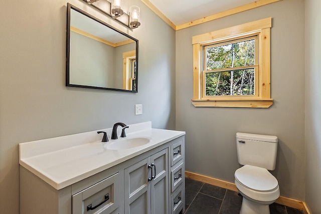 bathroom with toilet, vanity, and tile patterned floors