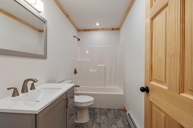 full bathroom featuring vanity, washtub / shower combination, hardwood / wood-style flooring, toilet, and a baseboard radiator