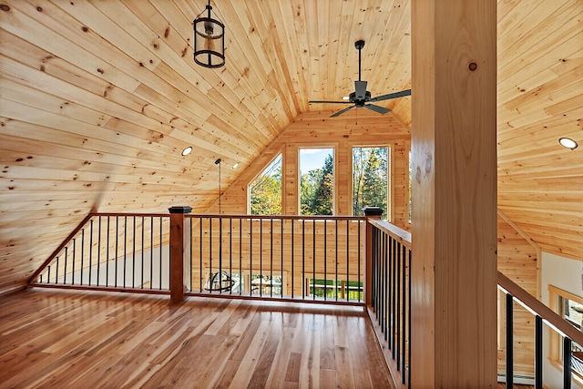 additional living space featuring ceiling fan, wood walls, wood ceiling, vaulted ceiling, and wood-type flooring