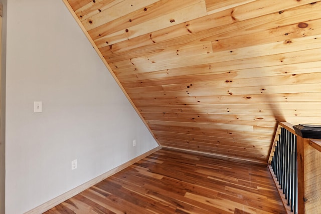 bonus room featuring wood walls, lofted ceiling, dark wood-type flooring, and wood ceiling